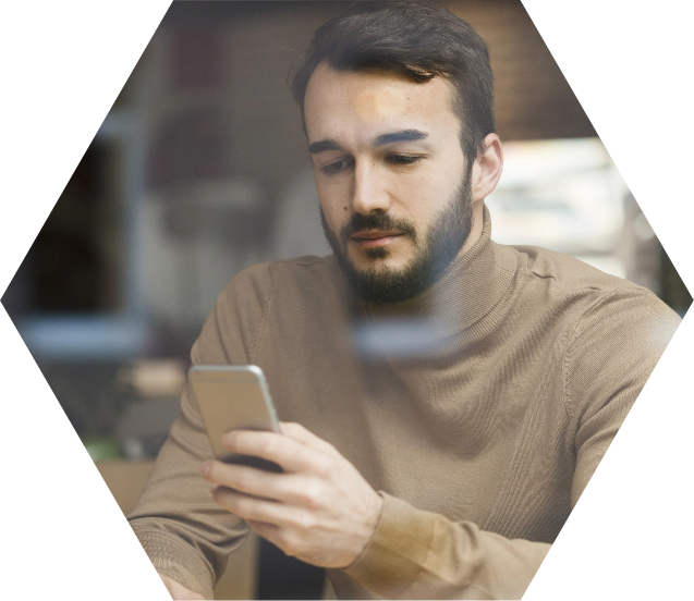 Photo of a man watching his phone